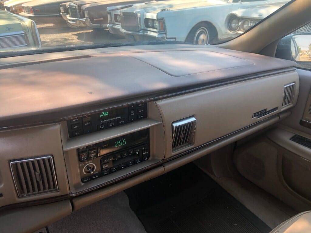 View of a vintage car dashboard with classic radio and air vents.
