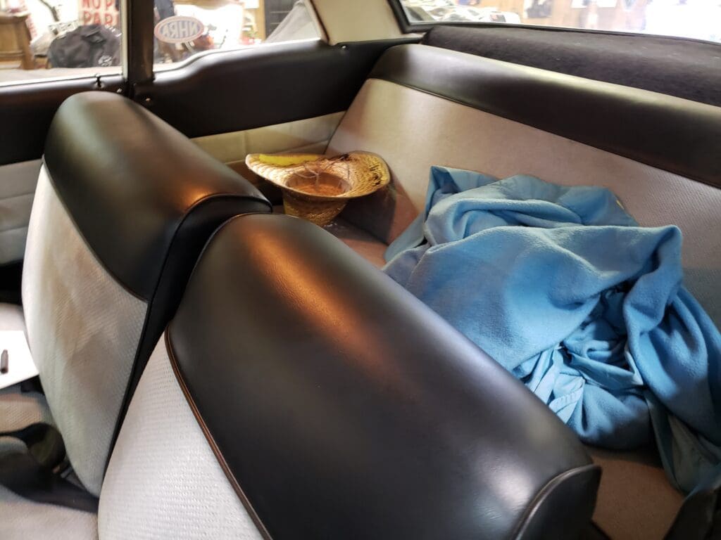 Car interior with black leather seats and a blue cloth on the seat.