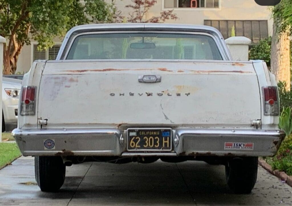 Rear view of a vintage Chevy car with California license plate.
