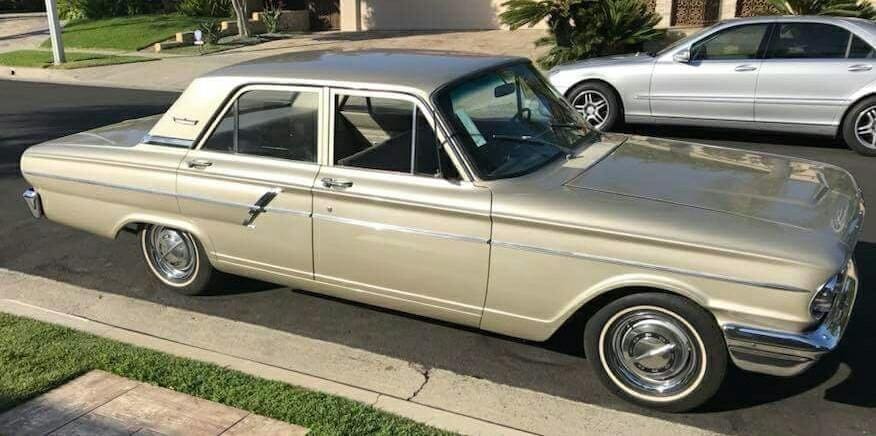 Classic vintage car parked on a suburban street.