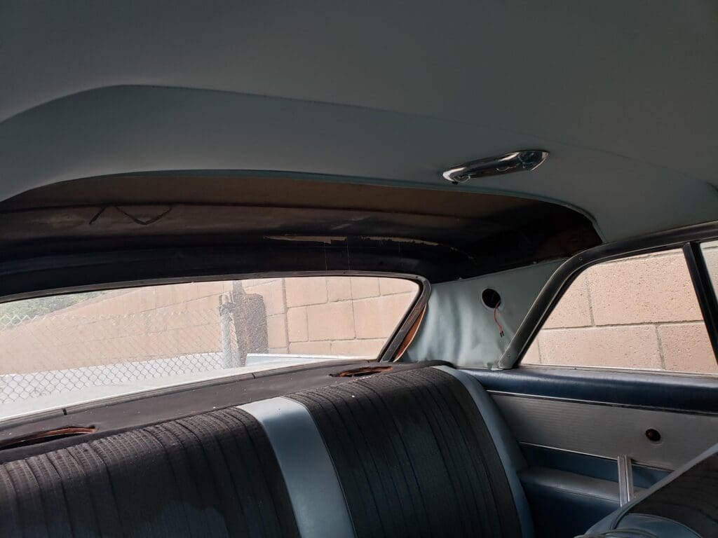 View of a car's interior focusing on the backseat and rear window.