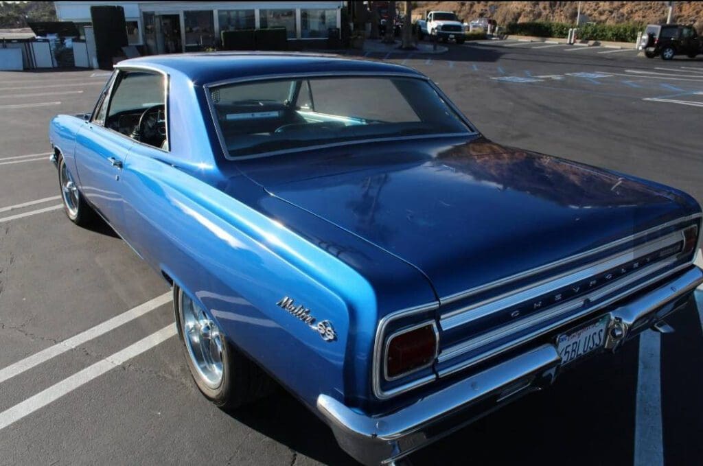 Classic blue Chevrolet Nova SS parked on a sunny street.
