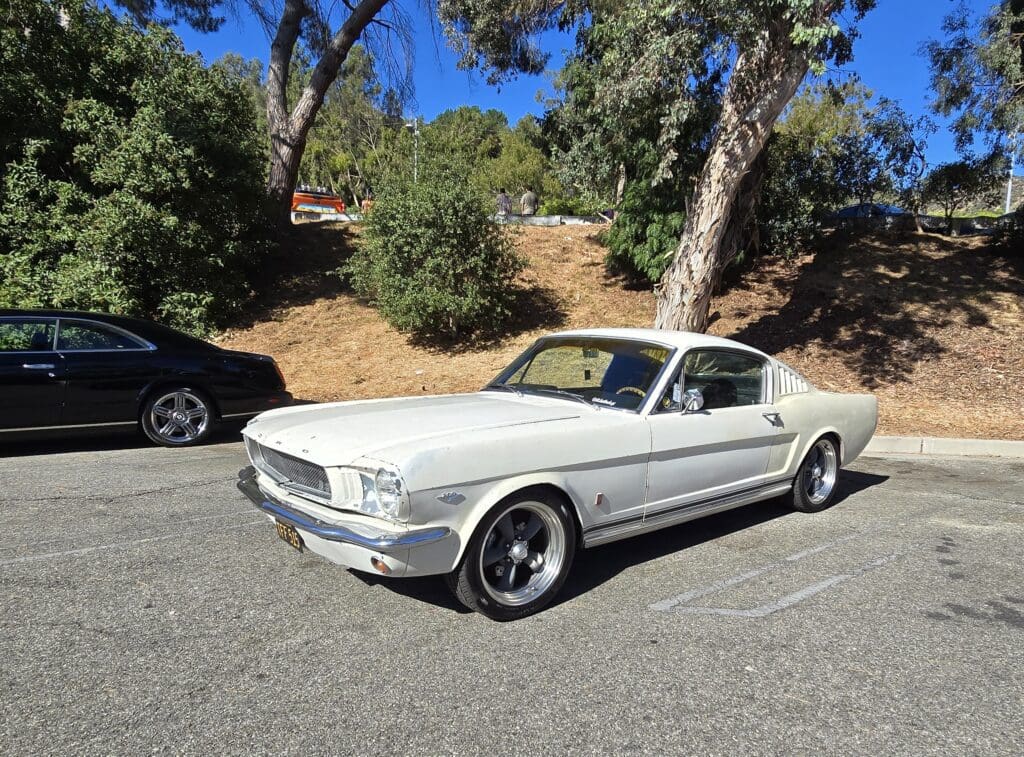 Classic white Ford Mustang parked on a sunny day.