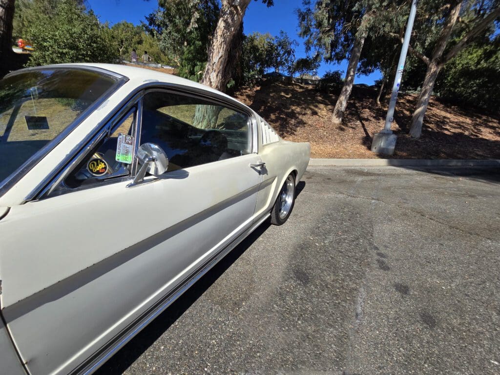Classic white Ford Mustang parked on a sunny day.
