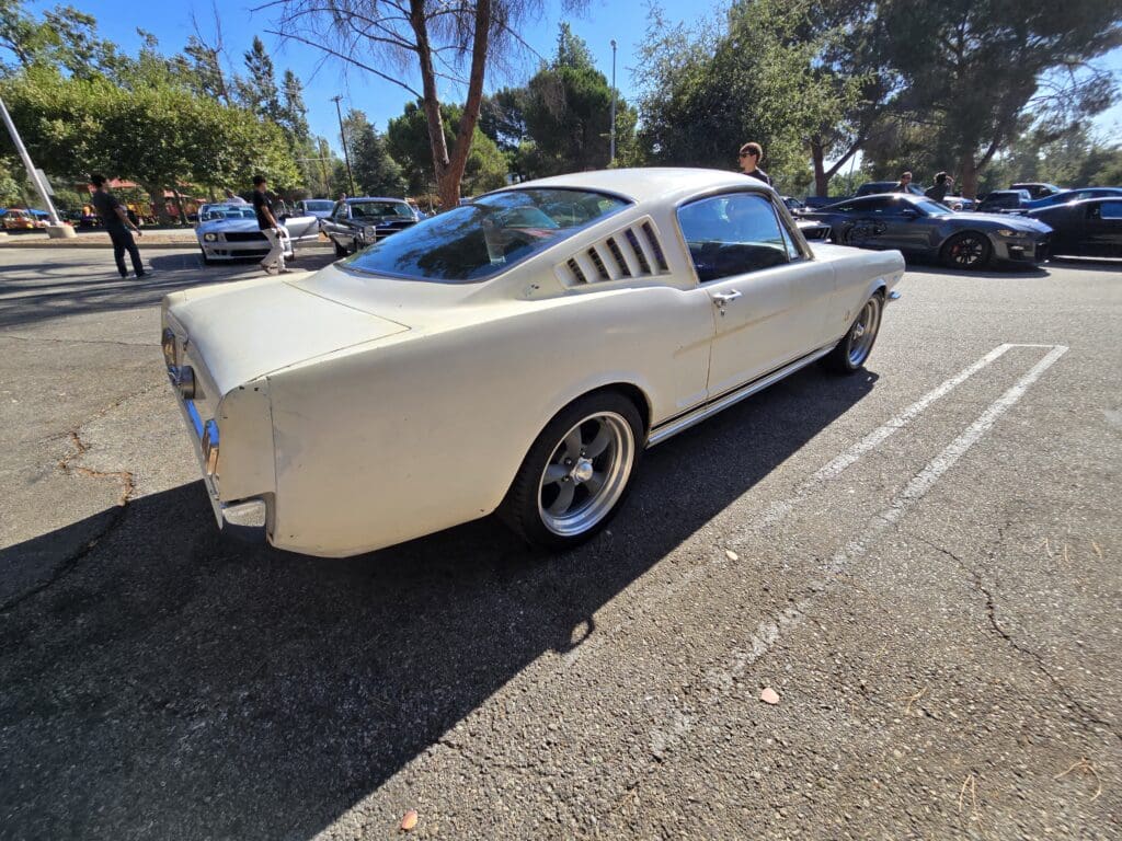 Classic white Ford Mustang parked on a sunny day.