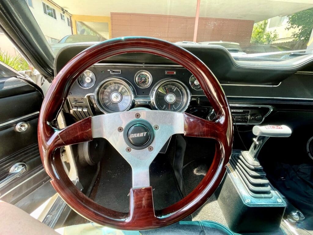 Vintage car steering wheel with classic dashboard.