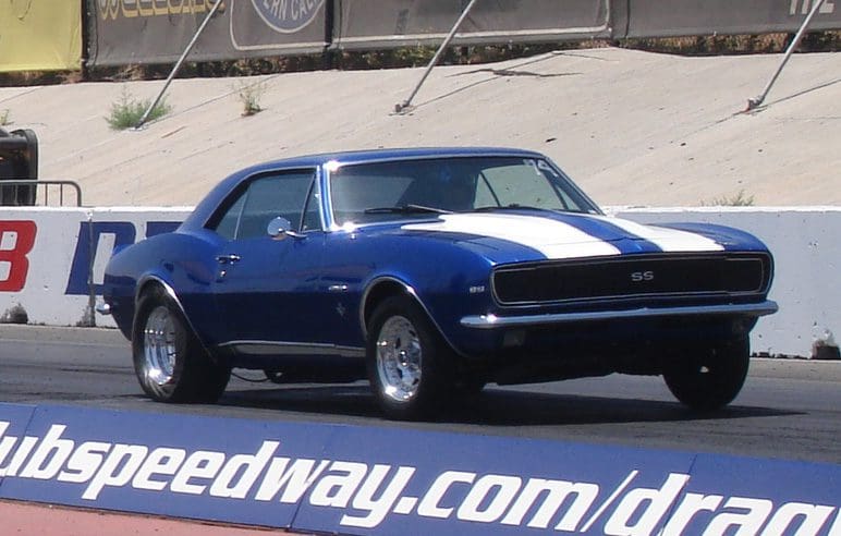 Classic blue and white 1969 Camaro SS parked on pavement.