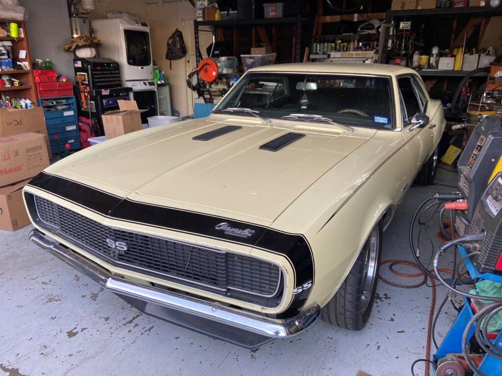 Classic vintage car in a garage undergoing restoration.