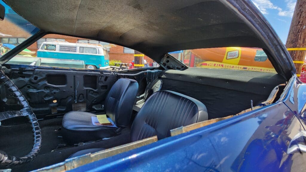 Interior of a classic car showing the dashboard and front seats.