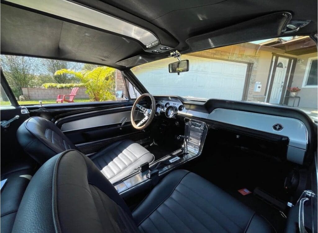 Interior of a vintage car showcasing a classic steering wheel and dashboard.