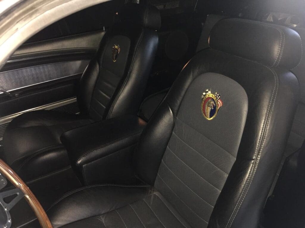 Black leather car seats with a distinctive emblem on the headrests.