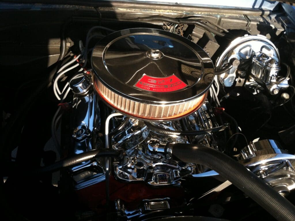 Classic light blue 1960s muscle car on display at an outdoor car show.