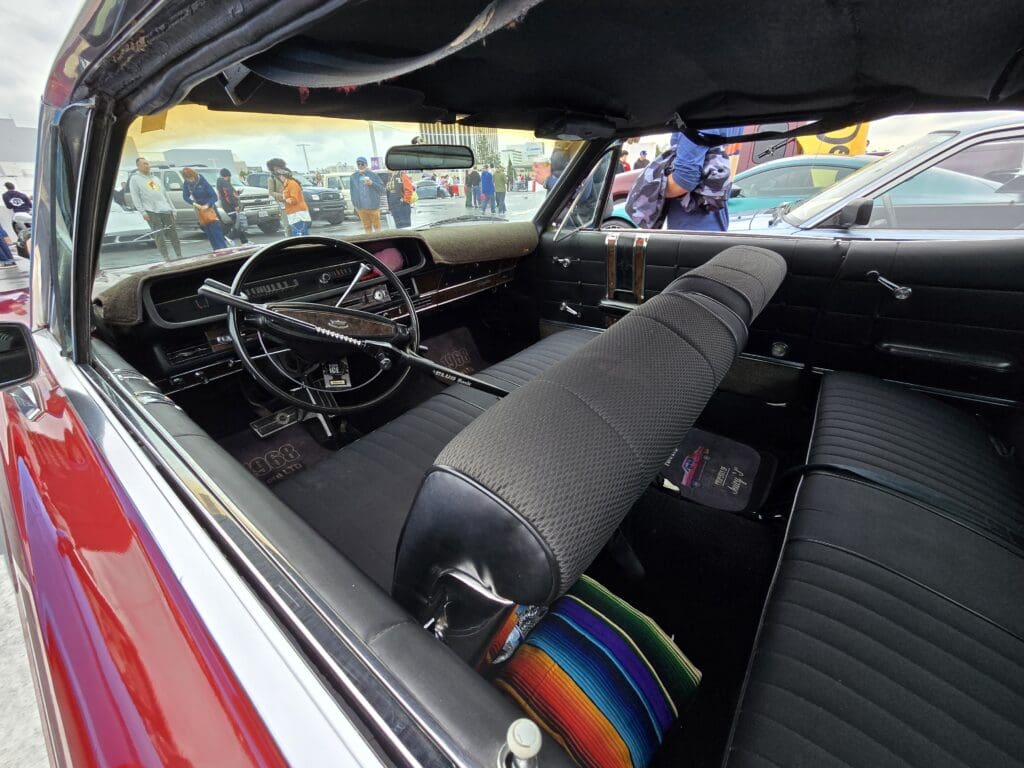 Interior of a classic car with vintage dashboard and bench seat.