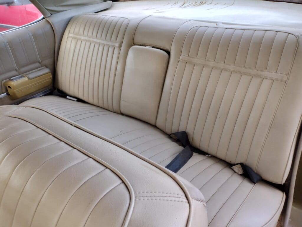 Beige leather car interior with clean, cushioned seats.
