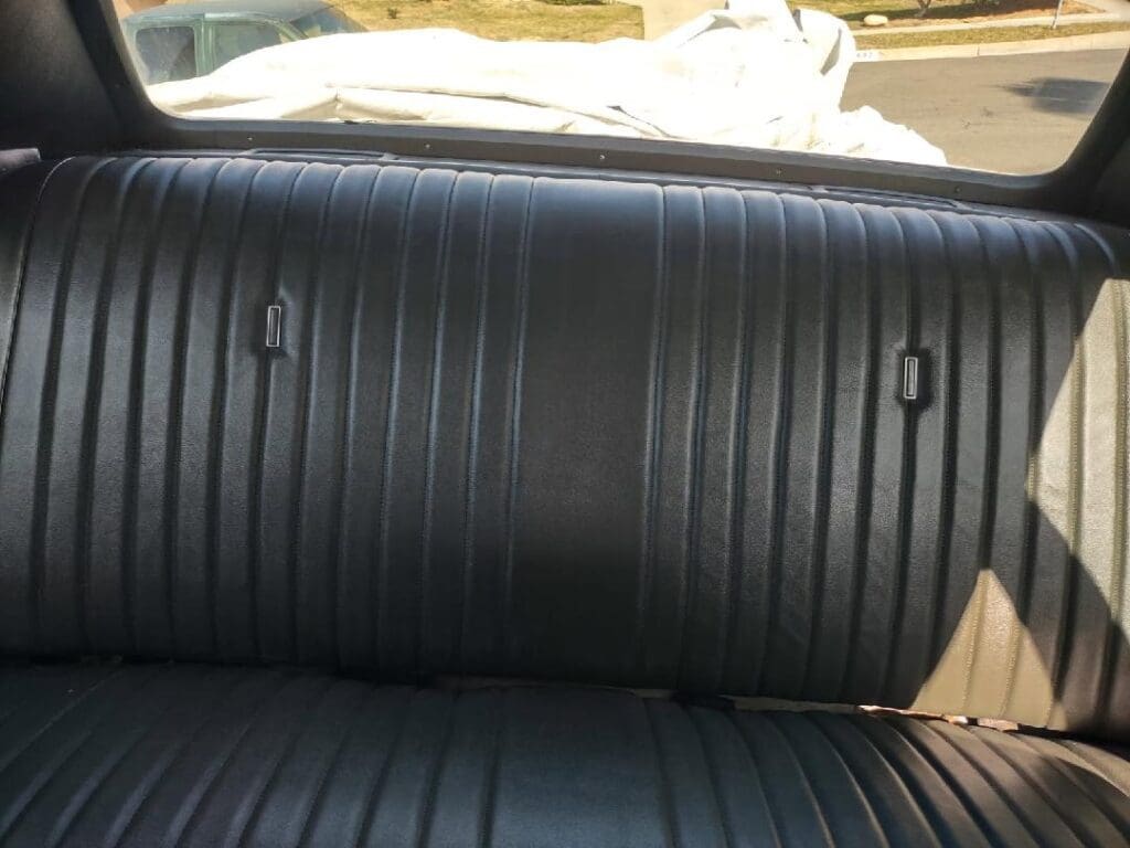 Close-up of black ribbed leather car seats.