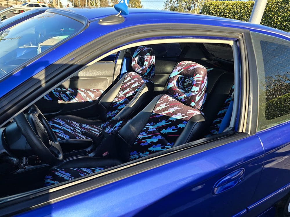 Blue car with sporty, colorful interior seats.