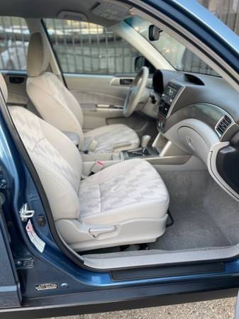 Clean interior of a car featuring beige quilted seats and modern dashboard.