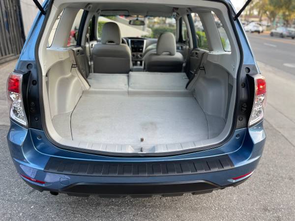 Empty car trunk with folded rear seats and clean interior.
