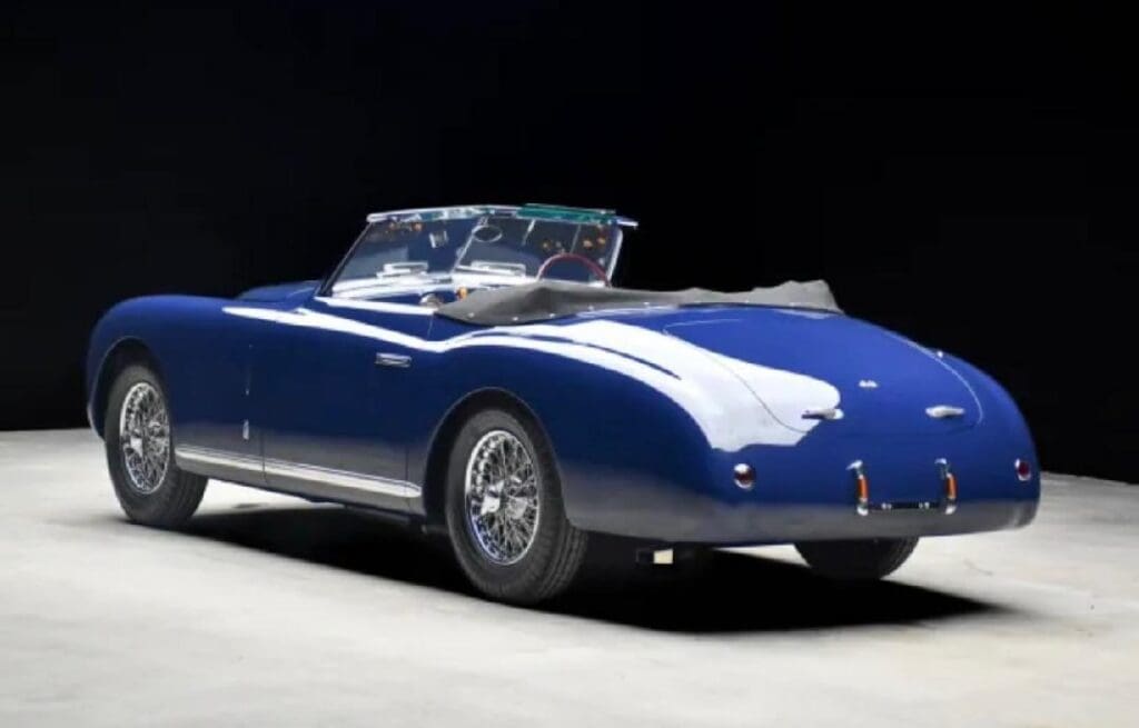 A sleek, classic blue convertible sports car on display.