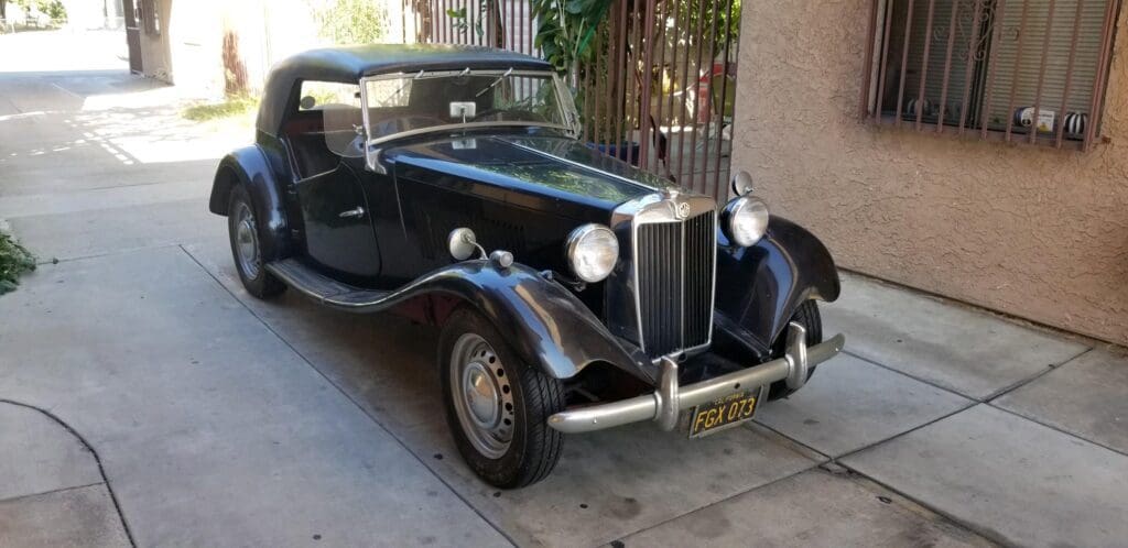 Classic black vintage convertible car parked on the street.