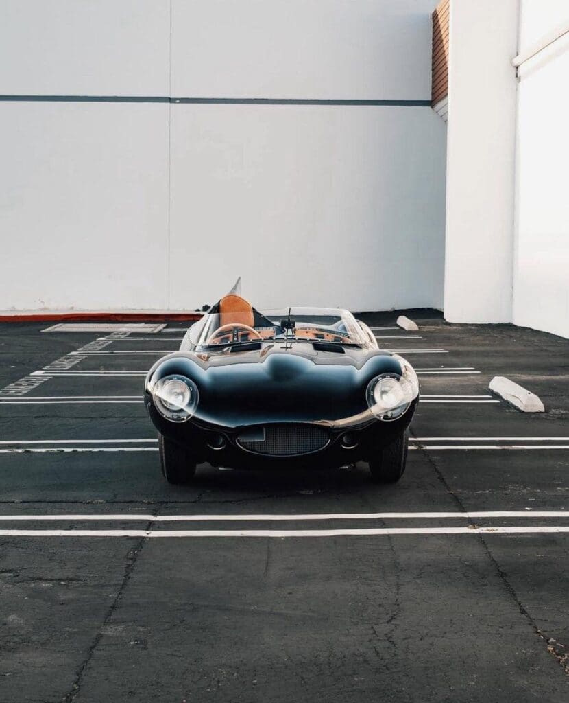 Vintage convertible sports car parked in an empty lot.