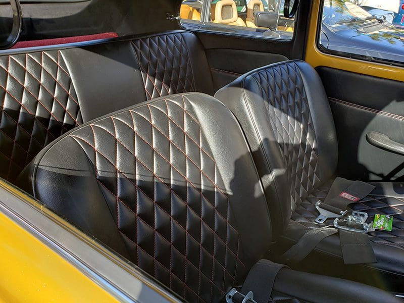 Luxurious diamond-stitched leather seats in a car's interior.
