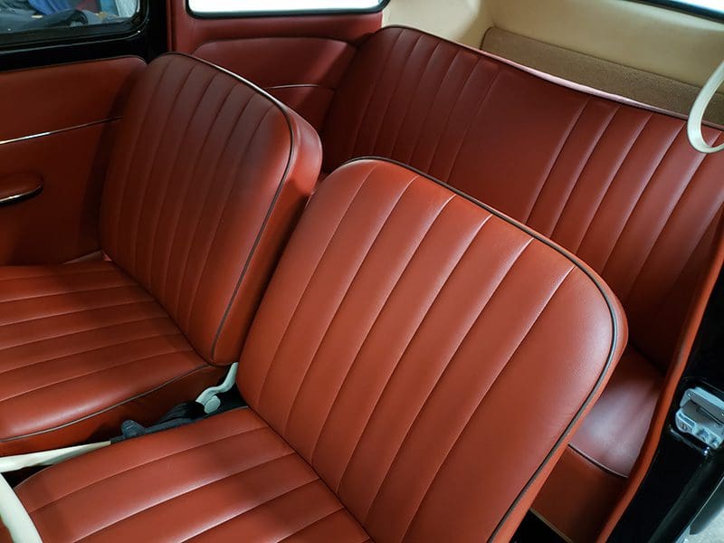 Interior of a car with vintage brown leather seats.