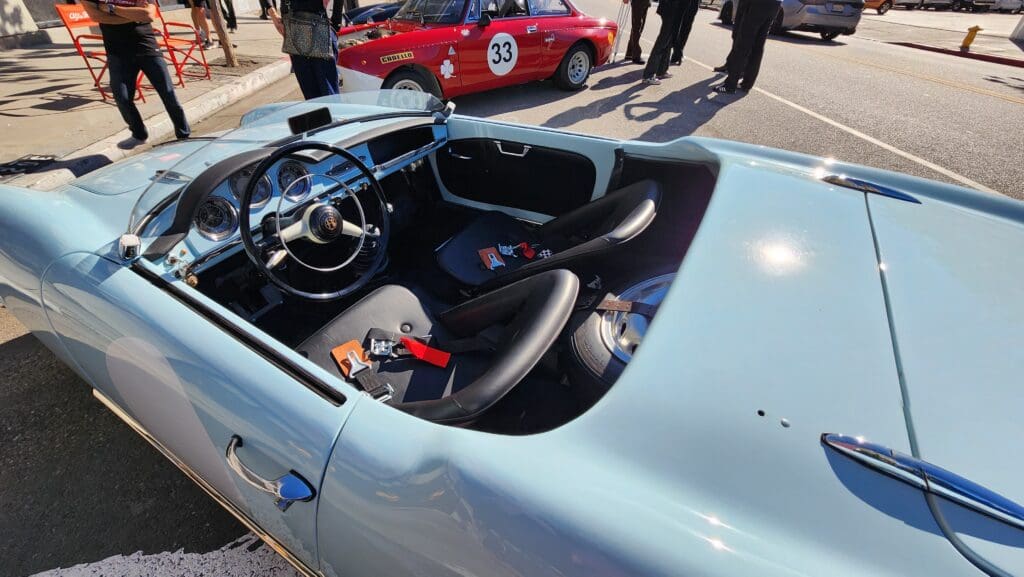 Light blue vintage convertible car parked outdoors on a sunny day.