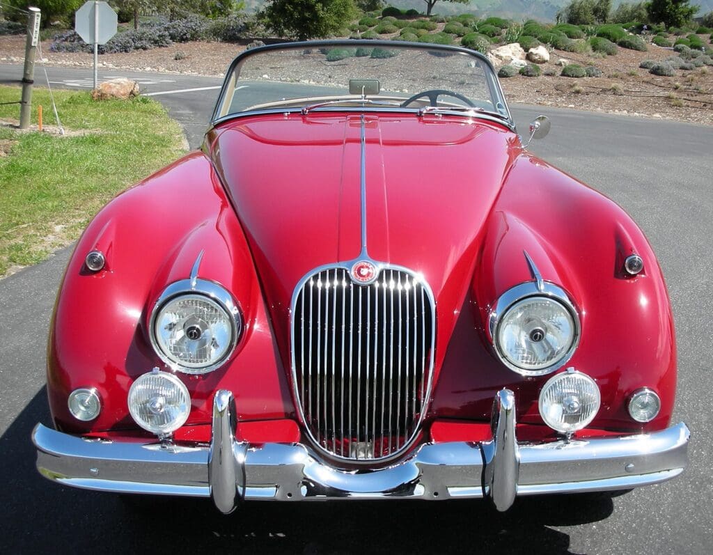 Classic red convertible sports car with shiny chrome accents.