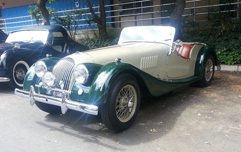 Classic vintage car with elegant green and cream exterior.