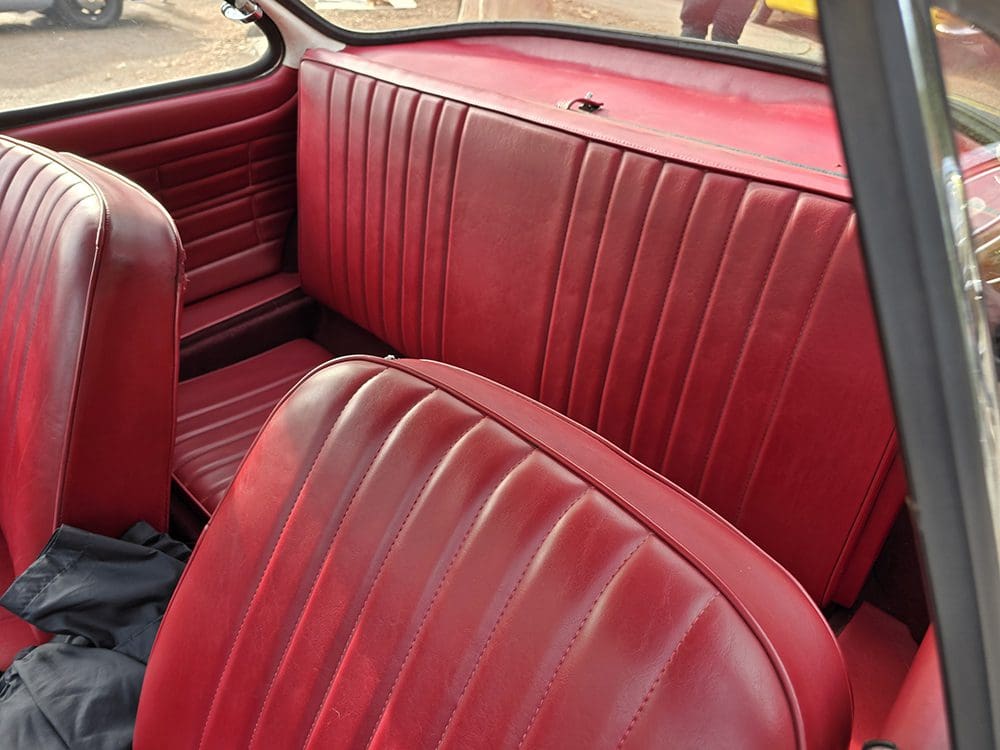 Red leather seats inside a classic car.