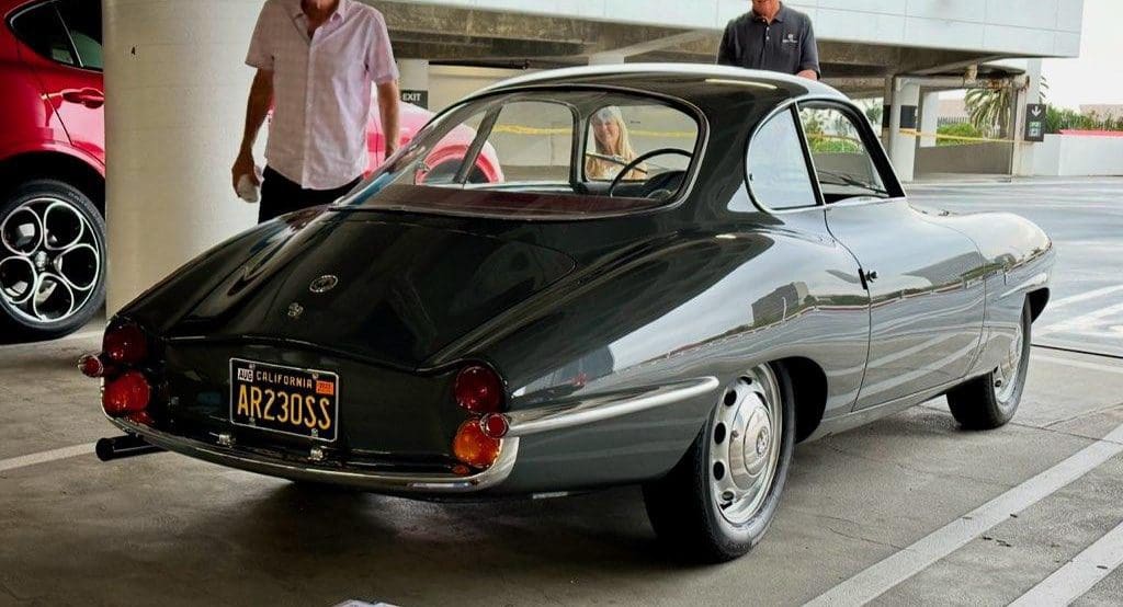 Classic black vintage sports car with sleek curves and chrome details.