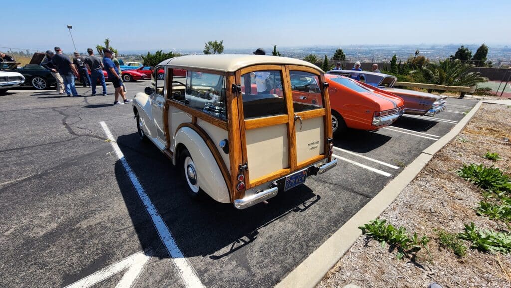 Classic woody station wagon parked with scenic ocean view.
