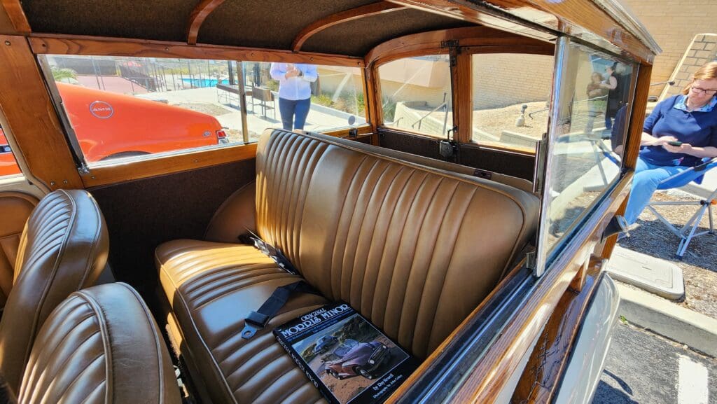 Vintage car's luxurious brown leather interior with polished wood accents.