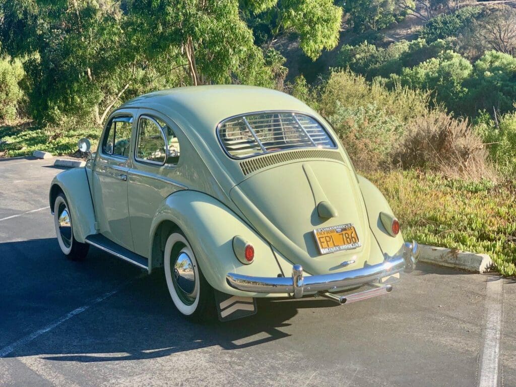 A classic vintage Volkswagen Beetle parked outdoors on a sunny day.