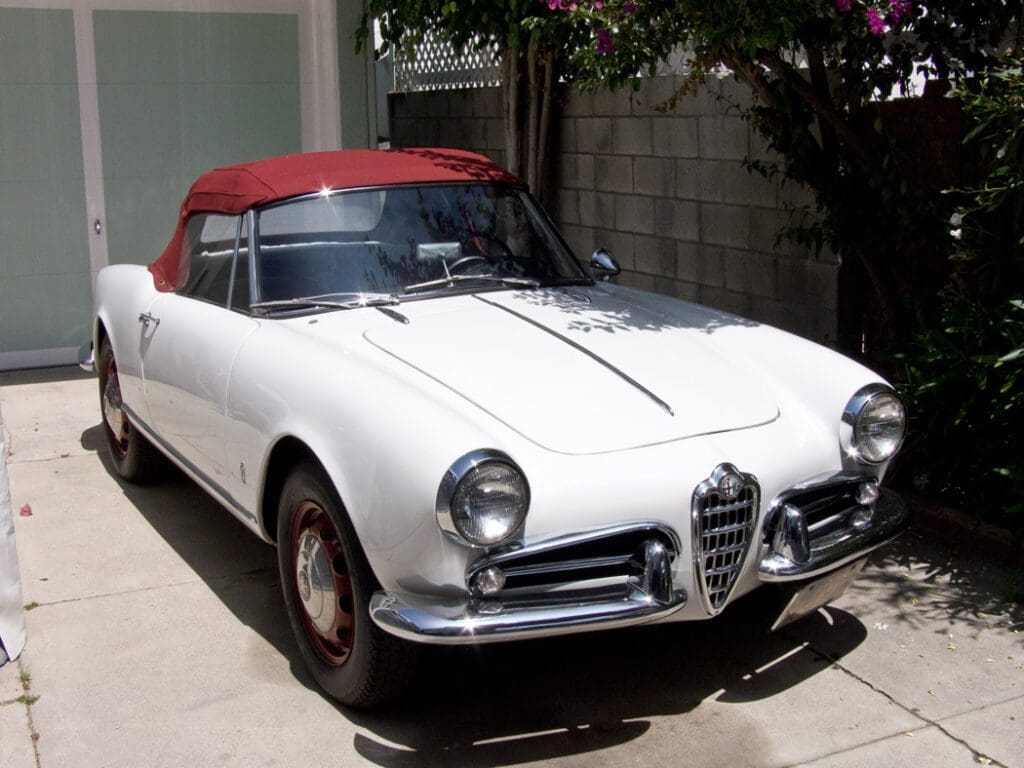 Classic white Alfa Romeo convertible with a red soft top.