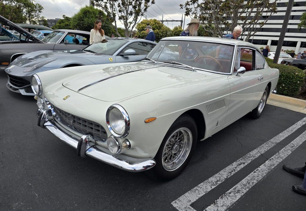 Classic white vintage sports car parked outdoors.