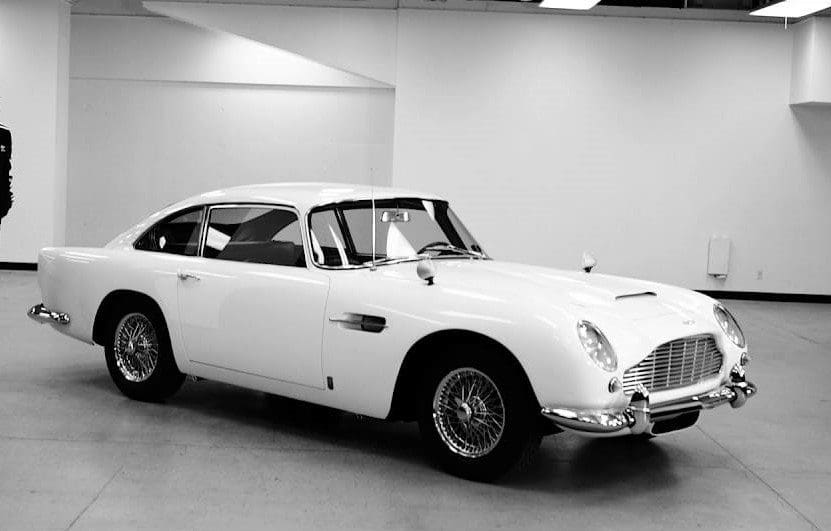 Classic white vintage car in a showroom.