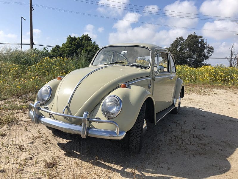 Classic vintage Volkswagen Beetle parked on a sunny day.