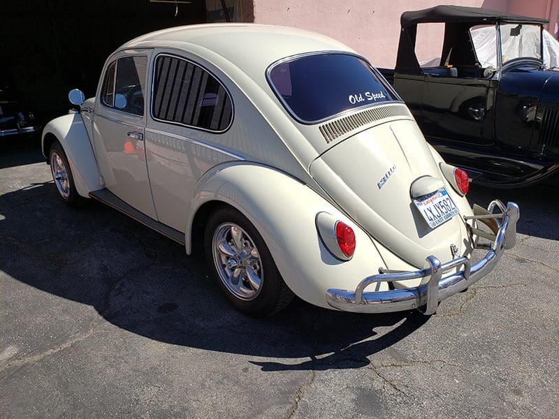 Classic white Volkswagen Beetle with polished chrome details.