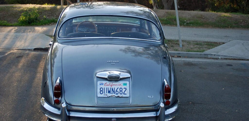 Vintage car parked on the street with a clear view of the license plate.