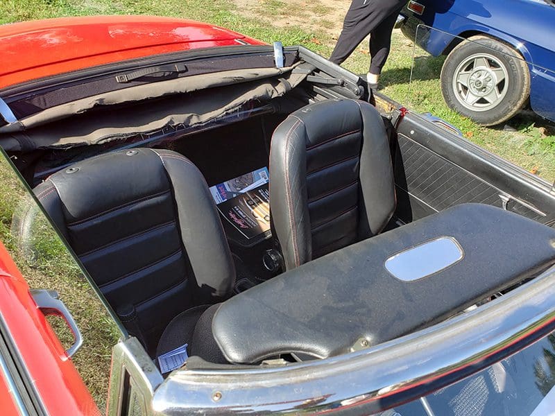 Close-up of a convertible car's interior with leather seats.
