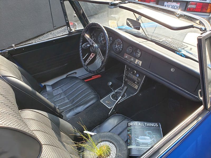 Interior of a vintage car with classic dashboard and leather seats.