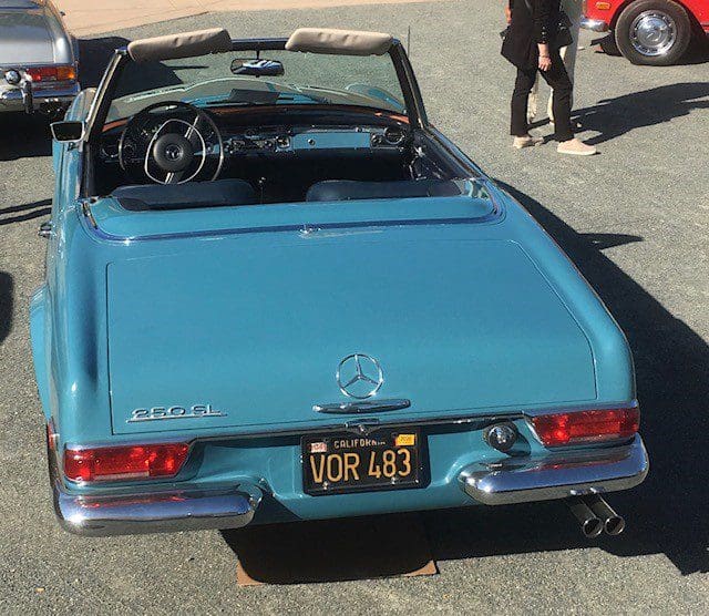 Classic blue Mercedes-Benz convertible parked outdoors.