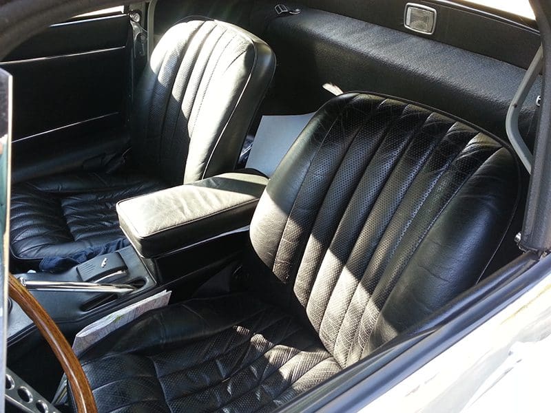 Black leather car seats with a classic design.