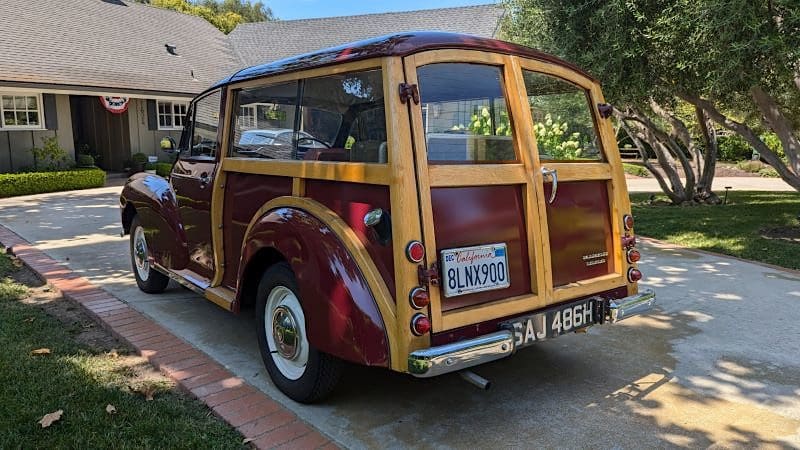 Classic wood-paneled vintage car parked on a street.