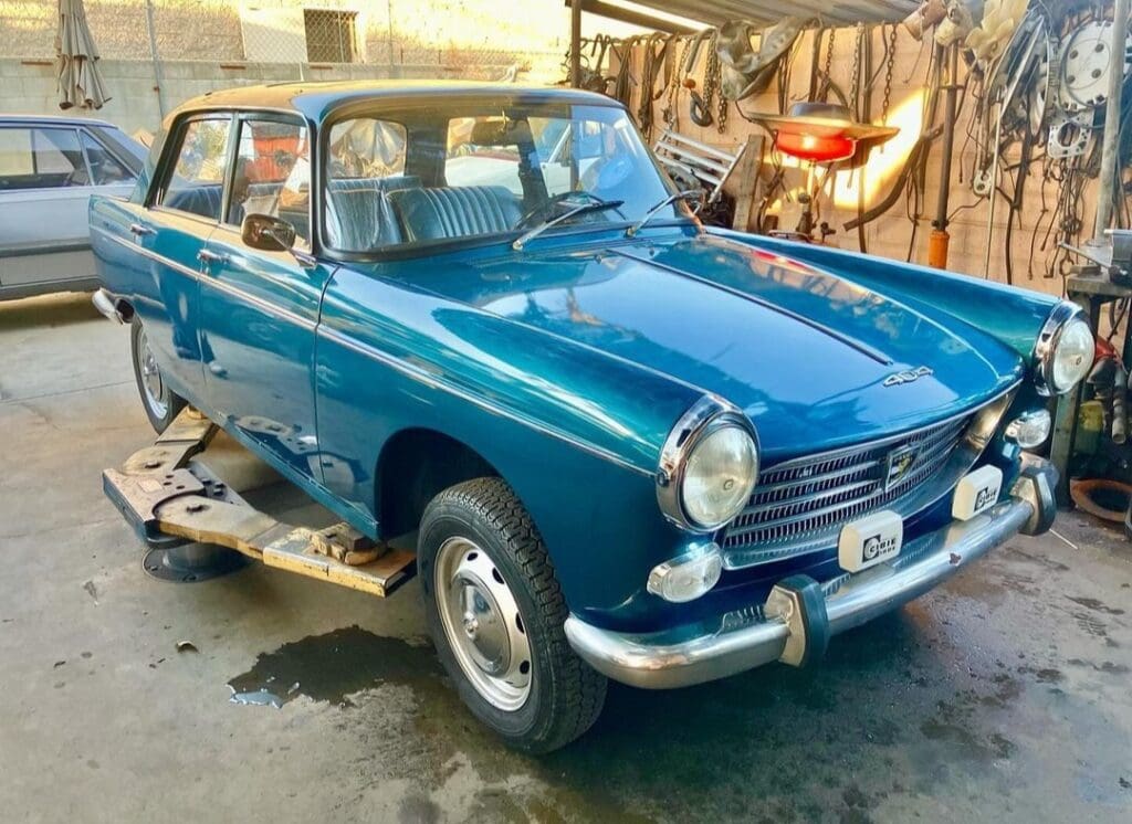 A classic blue vintage car parked indoors.