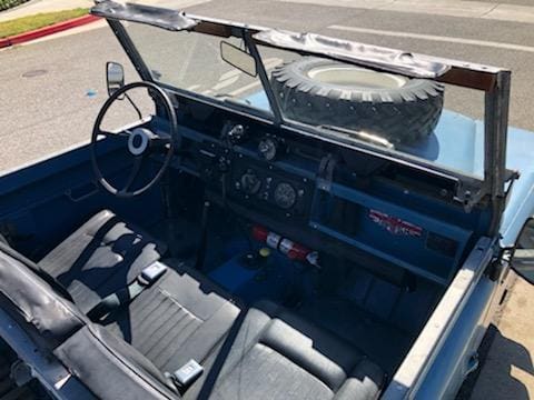 Interior view of a vintage open-top vehicle with a rugged design.