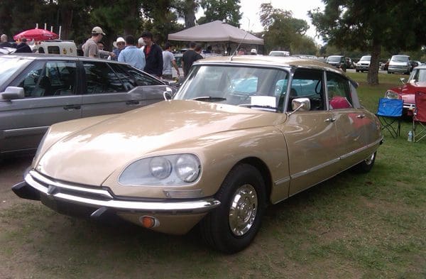 Classic beige Citroën DS car parked at an outdoor event.