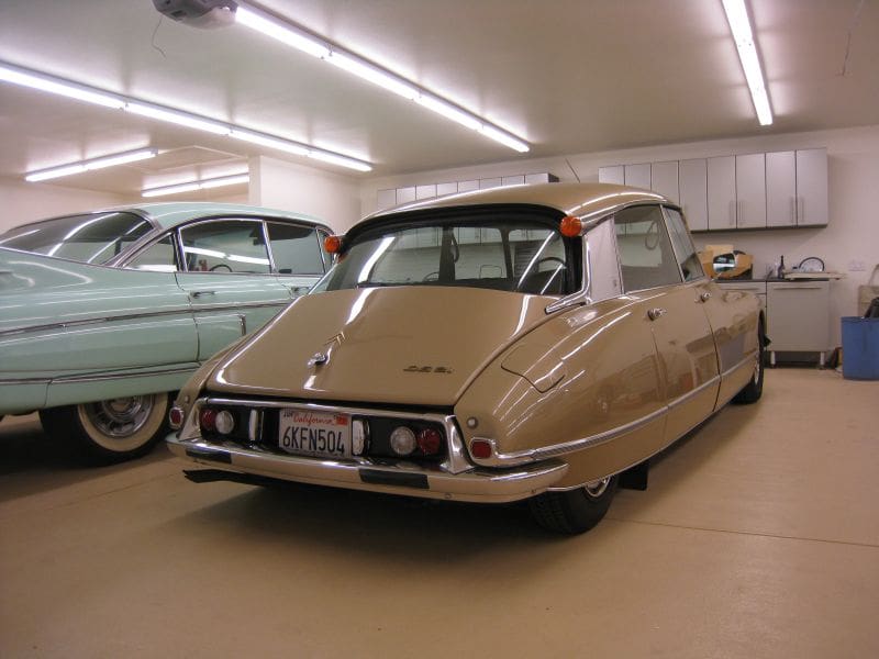 Classic beige Citro&euml;n DS parked indoors with vintage style lighting.